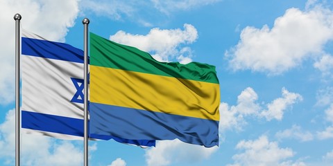 Israel and Gabon flag waving in the wind against white cloudy blue sky together. Diplomacy concept, international relations.