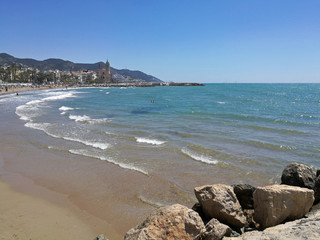 Beach and sea in Sitges Spain overlooking the church