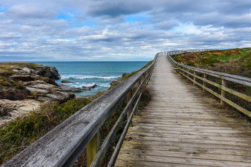 Boardwalk along the shoreline in a cloudy day