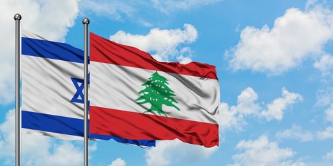 Fototapeta na wymiar Israel and Lebanon flag waving in the wind against white cloudy blue sky together. Diplomacy concept, international relations.