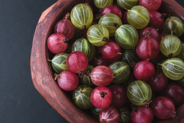 Fresh gooseberry in a bowl on a black background