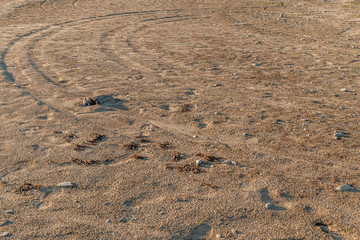 abstract background of tire tracks and soles on wet sand