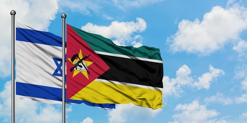 Israel and Mozambique flag waving in the wind against white cloudy blue sky together. Diplomacy concept, international relations.