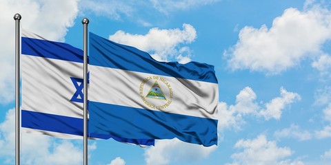 Israel and Nicaragua flag waving in the wind against white cloudy blue sky together. Diplomacy concept, international relations.
