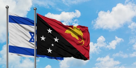 Israel and Papua New Guinea flag waving in the wind against white cloudy blue sky together. Diplomacy concept, international relations.