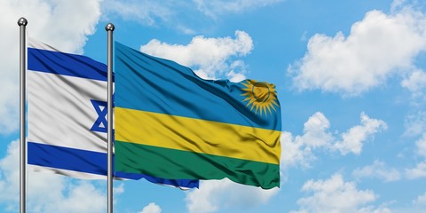 Israel and Rwanda flag waving in the wind against white cloudy blue sky together. Diplomacy concept, international relations.