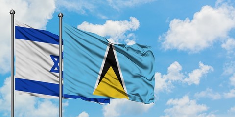 Israel and Saint Lucia flag waving in the wind against white cloudy blue sky together. Diplomacy concept, international relations.