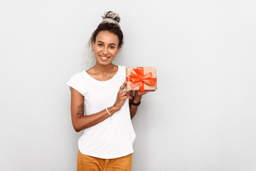 Positive optimistic happy young african woman with dreads isolated over white wall background...