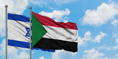 Israel and Sudan flag waving in the wind against white cloudy blue sky together. Diplomacy concept, international relations.