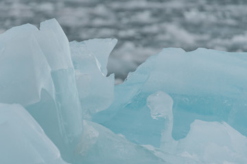 Close up of blue glacial ice floating in the sea in Svalbard