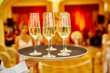 Waiter serving champagne on a tray