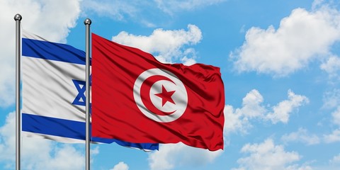 Israel and Tunisia flag waving in the wind against white cloudy blue sky together. Diplomacy concept, international relations.