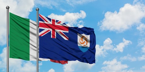 Italy and Anguilla flag waving in the wind against white cloudy blue sky together. Diplomacy...