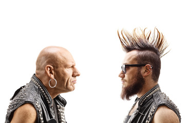 Young punker with a mohawk and an older bald punker looking at eachother