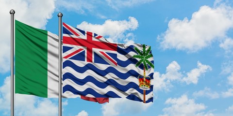 Italy and British Indian Ocean Territory flag waving in the wind against white cloudy blue sky together. Diplomacy concept, international relations.