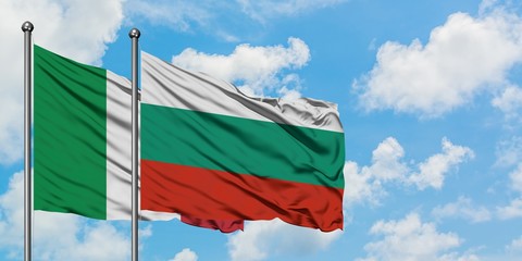 Italy and Bulgaria flag waving in the wind against white cloudy blue sky together. Diplomacy...
