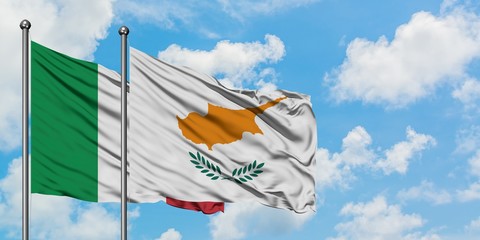 Italy and Cyprus flag waving in the wind against white cloudy blue sky together. Diplomacy concept,...