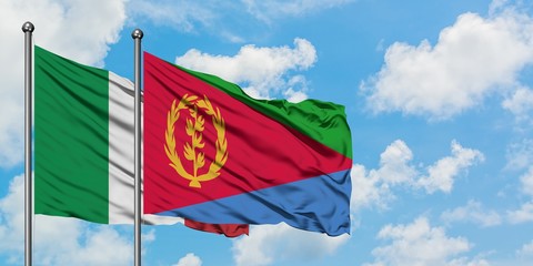 Italy and Eritrea flag waving in the wind against white cloudy blue sky together. Diplomacy concept, international relations.