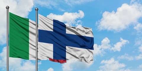 Italy and Finland flag waving in the wind against white cloudy blue sky together. Diplomacy concept, international relations.