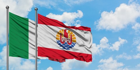 Italy and French Polynesia flag waving in the wind against white cloudy blue sky together. Diplomacy concept, international relations.