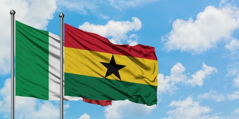 Italy and Ghana flag waving in the wind against white cloudy blue sky together. Diplomacy concept, international relations.