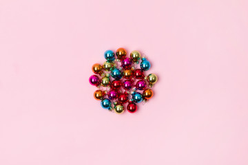 New Year Christmas top view flat lay colorful bauble with copy space on pink background