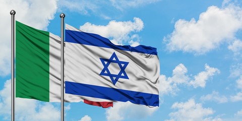 Italy and Israel flag waving in the wind against white cloudy blue sky together. Diplomacy concept, international relations.