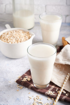 Healthy Alternative Milk. Homemade Oat Milk In Glass And Bottle On Light Table Lactose Free