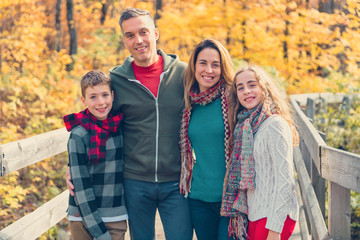 A portrait of a young family in the autumn park