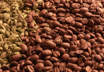 background from coffee beans and cardamom with burlap villi top view