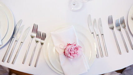 Spring table settings with fresh flower, napkin and silverware. Holidays background. Selective Focus.