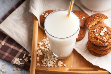 Healthy alternative milk. Homemade oat milk in glass and bottle on light table Lactose free Close up