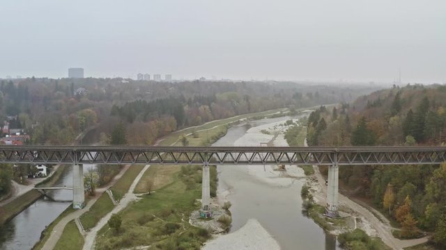 Der Blick über eine Brücke im Süden von München mit Blick auf der im Herbstnebel versinkenden Skyline der bayrischen Landeshauptstadt