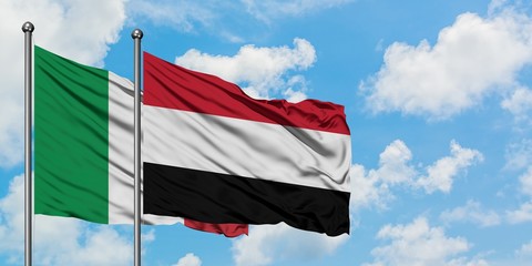 Italy and Yemen flag waving in the wind against white cloudy blue sky together. Diplomacy concept, international relations.
