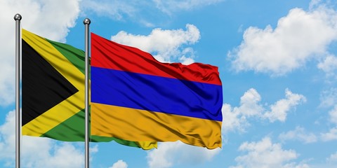 Jamaica and Armenia flag waving in the wind against white cloudy blue sky together. Diplomacy concept, international relations.
