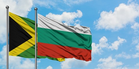 Jamaica and Bulgaria flag waving in the wind against white cloudy blue sky together. Diplomacy concept, international relations.