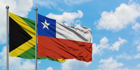 Jamaica and Chile flag waving in the wind against white cloudy blue sky together. Diplomacy...