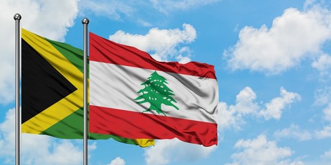 Jamaica and Lebanon flag waving in the wind against white cloudy blue sky together. Diplomacy concept, international relations.