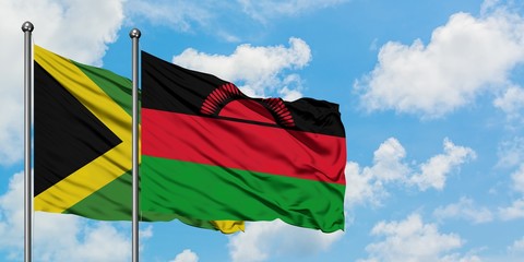 Jamaica and Malawi flag waving in the wind against white cloudy blue sky together. Diplomacy concept, international relations.