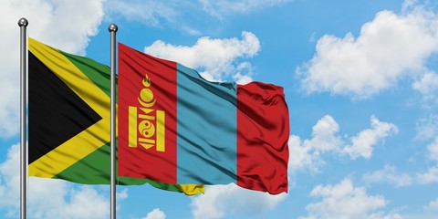 Jamaica and Mongolia flag waving in the wind against white cloudy blue sky together. Diplomacy concept, international relations.