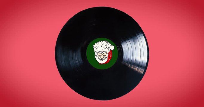 Black vinyl record  loop with Santa Claus in the middle of the disc isolated on red background