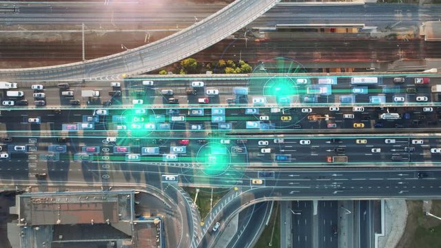 Beautiful aerial presentation of the autonomous cars self-driving concept on multi-level highway on the sunny evening in Moscow with 3 cars and their trajectories highlighted. 