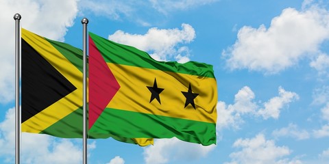 Jamaica and Sao Tome And Principe flag waving in the wind against white cloudy blue sky together. Diplomacy concept, international relations.