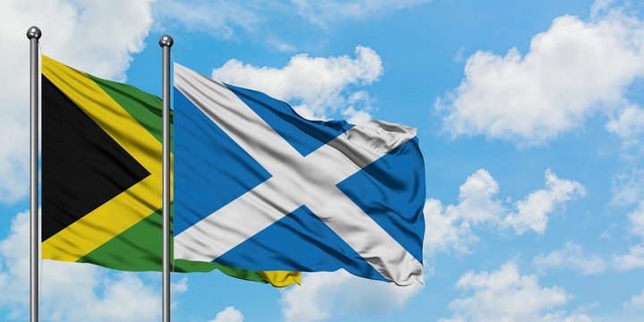 Jamaica and Scotland flag waving in the wind against white cloudy blue sky together. Diplomacy concept, international relations.