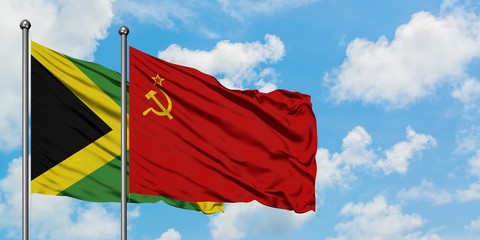 Jamaica and Soviet Union flag waving in the wind against white cloudy blue sky together. Diplomacy...