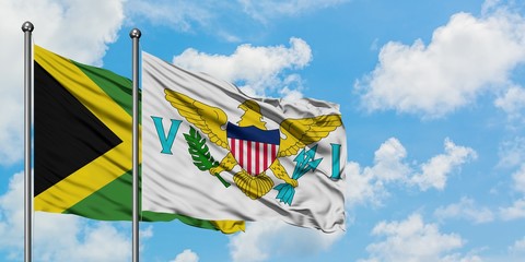 Jamaica and United States Virgin Islands flag waving in the wind against white cloudy blue sky together. Diplomacy concept, international relations.