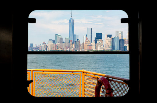 Fototapeta new york city skyline seen through a window from the staten Island ferry