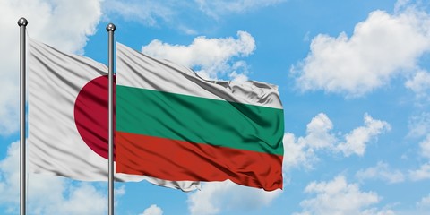 Japan and Bulgaria flag waving in the wind against white cloudy blue sky together. Diplomacy concept, international relations.