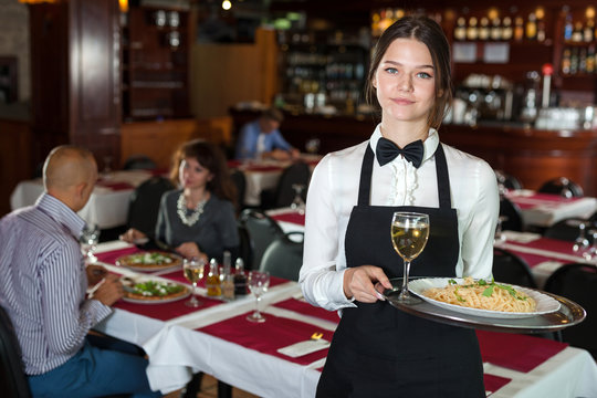 Smiling waitress with serving tray