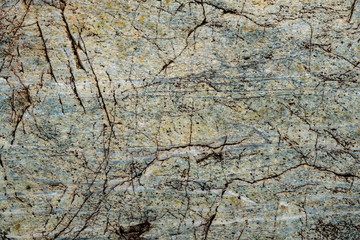 The texture of the stone overgrown with moss. Background image of a boulder